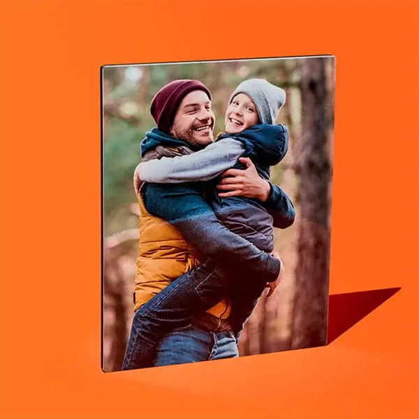 Square photo canvas showing an adult lifting a child outdoors in a woodland setting on an orange background